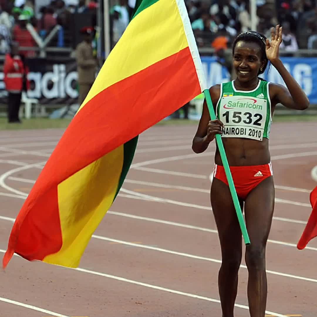Post by Nardos Honey: Ethiopia's Tirunesh Dibaba celebrates as she holds the Ethiopian national flag after finishing first in the women's...