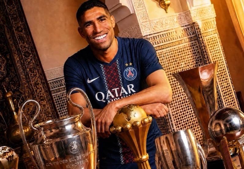 How Achraf Hakimi Became the Most Decorated African Footballer in History



⸻



🌍 INTRO: A NEW ERA HAS BEGUN



Football has always been a game of legends.



From the streets of Lagos to the stadiums of Casablanca, from dusty pitches in Abidjan to the roaring crowds of Europe — Africa has always produced greatness.



But every generation has one name that rises above the rest.



A name that defines dominance.

A name that rewrites history.



Today… that name is Achraf Hakimi.



At just 27 years old, Hakimi has reached a milestone no African player has ever touched:



19 career trophies.



More than icons.

More than legends.

More than history itself.



He is now officially:



The most decorated African player EVER.



And the craziest part?



He’s not even close to finished.



⸻



🏆 THE NUMBERS THAT SHOCKED THE WORLD



Let’s put things into perspective.



For years, African football royalty was dominated by names that felt untouchable:



* Samuel Eto’o — 18 trophies

* Yaya Touré — 18 trophies



Players who conquered Europe.

Players who defined excellence.



Then came Hakimi…



And quietly, relentlessly, he passed them all.



19 trophies.



Not hype.

Not potential.



Pure, undeniable achievement.



⸻



⚡ FROM MADRID TO GLOBAL DOMINATION



Hakimi’s journey didn’t start with headlines.



It started with belief.



Born in Spain to Moroccan parents, he came through the system at Real Madrid — one of the biggest clubs in football history.



But here’s the twist…



He wasn’t handed greatness.



He had to chase it.



⸻



🔄 THE JOURNEY THAT BUILT A KING



Most players stay comfortable.



Hakimi didn’t.



Instead, he took the harder path:



➡️ Real Madrid

➡️ Borussia Dortmund

➡️ Inter Milan

➡️ Paris Saint-Germain



Every move was a test.

Every league was a new battlefield.



And every single time?



He conquered.



⸻



🇩🇪 DORTMUND: THE BREAKOUT



At Borussia Dortmund, Hakimi became a weapon.



Not just a defender — but a machine.



* Blistering pace ⚡

* Attacking instincts 🎯

* Fearless confidence 💥



He wasn’t just playing football.



He was changing how full-backs are seen.



⸻



🇮🇹 INTER MILAN: THE PROOF



Then came Italy.



Serie A.

A league known for tactics, discipline, and defensive perfection.



Hakimi didn’t just adapt.



He dominated.



Winning the Serie A title proved one thing:



He wasn’t a system player.

He was a game changer.



⸻



🇫🇷 PSG: THE TROPHY FACTORY



Then came Paris.



And this is where things became unfair.



At PSG, Hakimi turned into a trophy machine:



* Ligue 1 titles 🏆

* Domestic cups 🏆

* Super cups 🏆



And most importantly…



Champions League glory.



Not once.

Not twice.



But three times.



⸻



🌍 EUROPEAN GLORY: BUILT FOR THE BIGGEST STAGE



The UEFA Champions League is where legends are made.



Pressure.

Intensity.

History.



And Hakimi?



He thrives in it.



Winning 3 Champions League titles puts him in an elite category — not just among Africans, but among football royalty.



⸻



🌎 GLOBAL DOMINANCE



Hakimi didn’t stop in Europe.



He conquered the world stage too:



* FIFA Club World Cup 🏆

* UEFA Super Cup 🏆



This is no longer just success.



This is global dominance.



⸻



🇲🇦 AFRICAN PRIDE: MORE THAN JUST CLUB SUCCESS



But greatness isn’t just about club football.



It’s about representing where you come from.



Hakimi has always carried Morocco on his back with pride.



Winning AFCON wasn’t just another trophy.



It was legacy.



It was for the continent.

It was for the culture.

It was for Africa.



⸻



🔥 WHAT MAKES HAKIMI DIFFERENT?



Let’s be honest…



There are many great players.



But Hakimi?



He’s different.



Here’s why:



⚡ 1. SPEED LIKE NO OTHER



He doesn’t run.



He flies.



Defenders can’t catch him.

Attackers can’t escape him.



⸻



🎯 2. ATTACKING MINDSET



Most defenders defend.



Hakimi attacks.



He creates chances.

Scores goals.

Changes games.



⸻



🧠 3. FOOTBALL IQ



He knows when to move.

Where to be.

How to win.



That’s not talent.



That’s intelligence.



⸻



💪 4. CONSISTENCY



Season after season.



League after league.



He delivers.



No excuses.



⸻



📊 THE TROPHY BREAKDOWN



Let’s take a closer look at his incredible collection:



* 🏆🏆🏆🏆🏆 Ligue 1

* 🏆🏆🏆 Champions League

* 🏆🏆🏆 French Super Cup

* 🏆🏆 Coupe de France

* 🏆 AFCON

* 🏆 Serie A

* 🏆 UEFA Super Cup

* 🏆 FIFA Club World Cup

* 🏆 German Super Cup

* 🏆 Spanish Super Cup



19 trophies.



At 27.



Let that sink in.



⸻



⏳ THE SCARIEST PART? HE’S JUST GETTING STARTED



Most players peak at 27.



Hakimi?



He’s still evolving.



Still improving.

Still winning.



Which raises one terrifying question:



How many trophies will he end up with?



25?

30?

More?



⸻



🐐 THE GOAT DEBATE: IS HE ALREADY #1?



Let’s talk about it.



Is Hakimi already the greatest African player ever?



Some will say no.



They’ll mention:



* Eto’o

* Drogba

* Yaya Touré



And they have a point.



But here’s the truth:



👉 None of them reached 19 trophies this early

👉 None of them dominated across this many leagues

👉 None of them are still this young with this much left



Hakimi isn’t just catching up.



He’s pulling ahead.



⸻



💭 LEGACY VS GREATNESS



There’s a difference between being great…



And being unforgettable.



Hakimi is building something bigger than stats.



He’s building:



* Influence

* Inspiration

* Identity



For millions of African kids watching him…



He represents possibility.



⸻



🌍 IMPACT BEYOND FOOTBALL



Hakimi’s success means more than trophies.



It means:



* African talent is global 🌍

* Hard work beats comfort 💪

* Dreams are valid ✨



He’s not just winning for himself.



He’s winning for a continent.



⸻



🚨 FINAL VERDICT: THE KING HAS ARRIVED



This is no longer a debate.



No longer a prediction.



No longer a possibility.



Achraf Hakimi is:



👑 The King of African football (by trophies)

🏆 The most decorated African player in history

⏳ A legend still in the making



⸻



💬 FINAL QUESTION (ENGAGEMENT BOOST)



Let’s talk 👇



Do you think Hakimi is already the greatest African player ever…



Or does he still have more to prove? 🤔



⸻



📈 BUZZER VIRAL STRATEGY (USE THIS AS YOUR CAPTION)



HOOK CAPTION:



🚨 Hakimi just became the MOST DECORATED African player EVER 🤯👑



19 trophies at 27…



Is he already the GOAT of African football? 🐐🌍



👇 Debate below